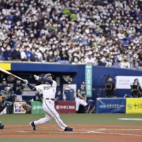 Masataka Yoshida hits a game-winning two-run home run against the Swallows in Game 5 of the Japan Series in Osaka on Thursday. | KYODO