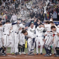 The Buffaloes celebrate after Masataka Yoshida's walk-off two-run home run against the Swallows in the ninth inning in Game 5 of the Japan Series in Osaka on Thursday. | KYODO