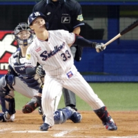 Swallows pinch hitter Soma Uchiyama hits a game-tying three-run homer in the ninth inning against the Buffaloes in Game 2 of the Japan Series at Jingu Stadium on Sunday. | KYODO