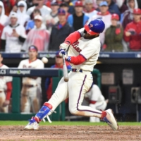 Phillies designated hitter Bryce Harper hits a two-run home run in the eighth inning against the Padres during Game 5 of the NLCS in Philadelphia on Sunday. | USA TODAY / VIA REUTERS