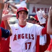 Shohei Ohtani is greeted in the Angels dugout after scoring a run against the Rangers in Anaheim, California, on Sunday. | USA TODAY / VIA REUTERS
