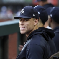 New York Yankees center fielder Aaron Judge smiles in the dugout during a game against the Texas Rangers at Globe Life Field, in Arlingotn, Texas, on Oct. 5. | USA TODAY / VIA REUTERS