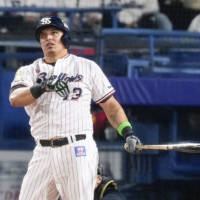 Jose Osuna watches his solo home run against Orix during Game 1 of the Japan Series at Jingu Stadium on Saturday. | KYODO