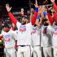 Phillies designated hitter Bryce Harper (second from left) and teammates celebrate after defeating the Padres in Game 5 of the NLCS at Citizens Bank Par, in Philadelphia, on Saturday. | USA TODAY / VIA REUTERS