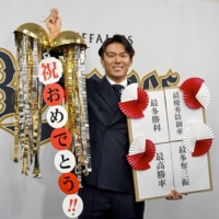 Buffaloes pitcher Yoshinobu Yamamoto poses for a photo in Osaka after signing his contract for next season on Tuesday. | KYODO
