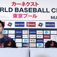 Samurai Japan player Shohei Ohtani (left) and manager Hideki Kuriyama speak during a news conference on Friday. | KYODO