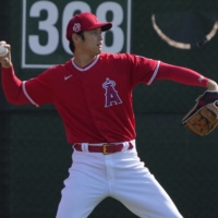 The Angels' Shohei Ohtani warms up during spring training in Tempe, Arizona, on Thursday. | USA TODAY