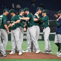 The Australia team celebrates its 8-3 win against the Czech Republic their World Baseball Classic Pool B game in Tokyo on Monday. | AFP-JIJI
