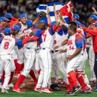 The Cuban team celebrates after defeating Australia in the quarterfinals of the World Baseball Classic at Tokyo Dome on Wednesday. | AFP-JIJI