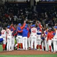 Members of Cuba's team celebrate their 4-3 victory in the World Baseball Classic game against Australia in Tokyo on March 15. | AFP-JIJI