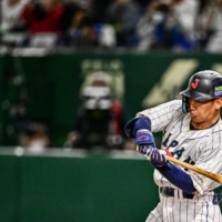 Japan outfielder Masataka Yoshida hits a single against the Czech Republic during their game at the World Baseball Classic at Tokyo Dome on Saturday. | AFP-JIJI