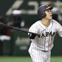 Japan outfielder Kensuke Kondo hits a home run against South Korea during the fifth inning at Tokyo Dome on Friday. | KYODO
