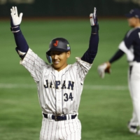 Japan outfielder Masataka Yoshida celebrates after hitting a two-run single against South Korea during the World Baseball Classic at Tokyo Dome on Friday. | REUTERS