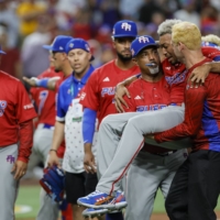 Puerto Rico pitcher Edwin Diaz is carried off the field after injuring his leg following his team's win over the Dominican Republic at the World Baseball Classic in Miami on Wednesday. | USA TODAY / VIA REUTERS