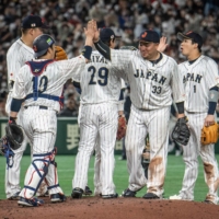 Japan's players celebrate their victory against the Czech Republic in Pool B of the World Baseball Classic at Tokyo Dome on Saturday. | AFP-JIJI