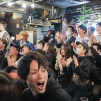Fans applause in Shibuya on Wednesday as they watch Japan's World Baseball Classic final against the United States. | LOUISE CLAIRE WAGNER