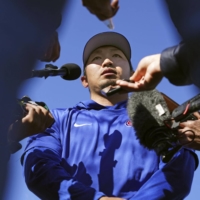 Cubs outfielder Seiya Suzuki speaks to reporters at the team's spring training camp in Mesa, Arizona, on Tuesday. | KYODO