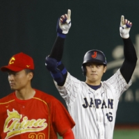 Shohei Ohtani celebrates after smashing a two-run double in the fourth inning against China in a World Baseball Classic game at Tokyo Dome on Thursday. | REUTERS