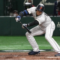 Shohei Ohtani lays down a bunt during the third inning of Japan's quarterfinal game against Italy in the World Baseball Classic at Tokyo Dome on Thursday. | AFP-JIJI
