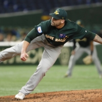 Australia's Tim Atherton pitches against the United States during the Premier12 at Tokyo Dome in November 2019. | KYODO 