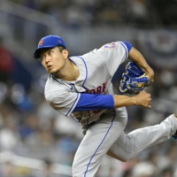 Mets starter Kodai Senga pitches against the Marlins in Miami on Sunday. Senga struck out eight and earned a win in his MLB debut. | 5-1