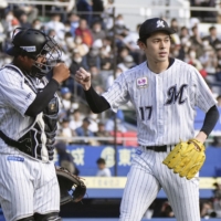 Marines pitcher Roki Sasaki (right) and catcher Ko Matsukawa leave the field after retiring the Fighters in the bottom of the sixth inning at Zozo Marine Stadium in Chiba on Thursday. | KYODO