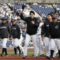 Roki Sasaki (center) acknowledges the fans after the Marines' win over the Fighters on Thursday. | KYODO