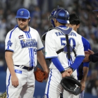 BayStars pitcher Trevor Bauer (left) allowed eight hits in just two innings against the Carp in Yokohama on Tuesday. | KYODO