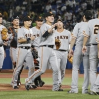 The Giants celebrate following their win over the Swallows at Jingu Stadium on Thursday. | KYODO