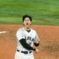 Shohei Ohtani throws his hat after striking out Mike Trout to record the last out of Japan's victory over the United States in the World Baseball Classic final in Miami on March 21. | USA TODAY / VIA REUTERS