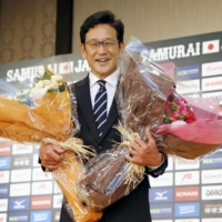 Samurai Japan manager Hideki Kuriyama poses for photos during a news conference on Friday after stepping down from the position. | KYODO