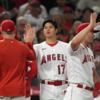 Los Angeles Angels starting pitcher Shohei Ohtani celebrates after the team's win over the Chicago White Sox on Tuesday. | USA TODAY / VIA REUTERS