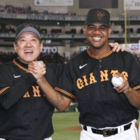 Giants pitcher Yohander Mendez poses with manager Tatsunori Hara following the team's win over the Lions at Tokyo Dome on Tuesday. | KYODO