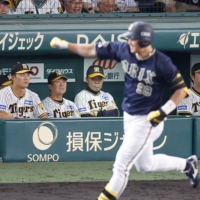 The Buffaloes' Yutaro Sugimoto rounds the bases after hitting a home run against the Tigers at Koshien Stadium in Nishinomiya, Hyogo Prefecture, on Thursday. | KYODO