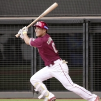 The Eagles' Hiroto Kobukata drives in the go-ahead run in the top of the ninth against the Fighters in Kitahiroshima, Hokkaido, on Thursday. | KYODO