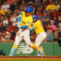 Masataka Yoshida hits a two-run home run against the Braves in Boston on Tuesday. | USA TODAY / VIA REUTERS