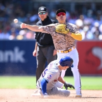 Padres second baseman Kim Ha-seong throws to first to complete a double play against the Mets during their game in San Diego, California, on July 9 | USA TODAY / VIA REUTERS