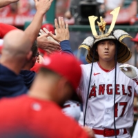 Shohei Ohtani celebrates in the dugout after his 36th home run of the season during a win over the Pirates in Anaheim, California, on Sunday. | USA TODAY / VIA REUTERS