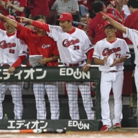 Carp manager Takahiro Arai (center) has the team pointed in the right direction in his first season in the dugout. | KYODO