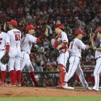 The Carp celebrate their win over Chunichi in Hiroshima on Saturday. | KYODO
